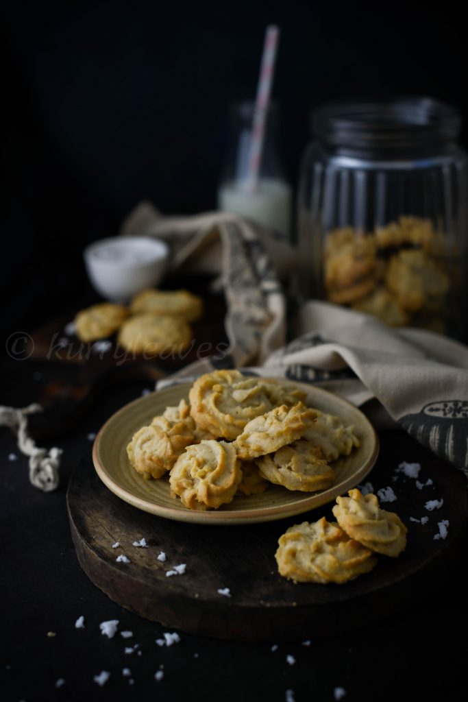 eggless wheat cookies on a platter with milk and cookie jar